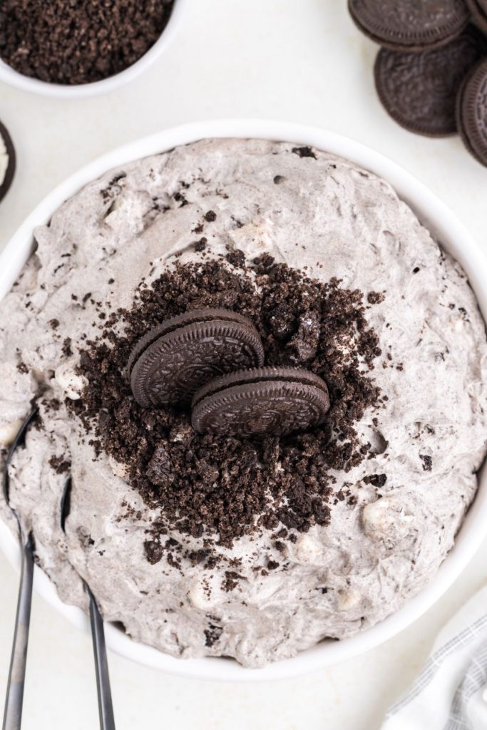 Bowl of oreo fluff dessert with two spoons in it.