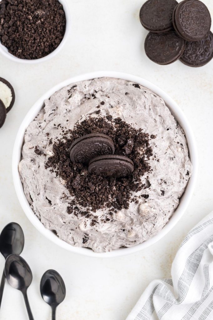 Bowl of Oreo fluff topped with crushed Oreos and 2 whole cookies