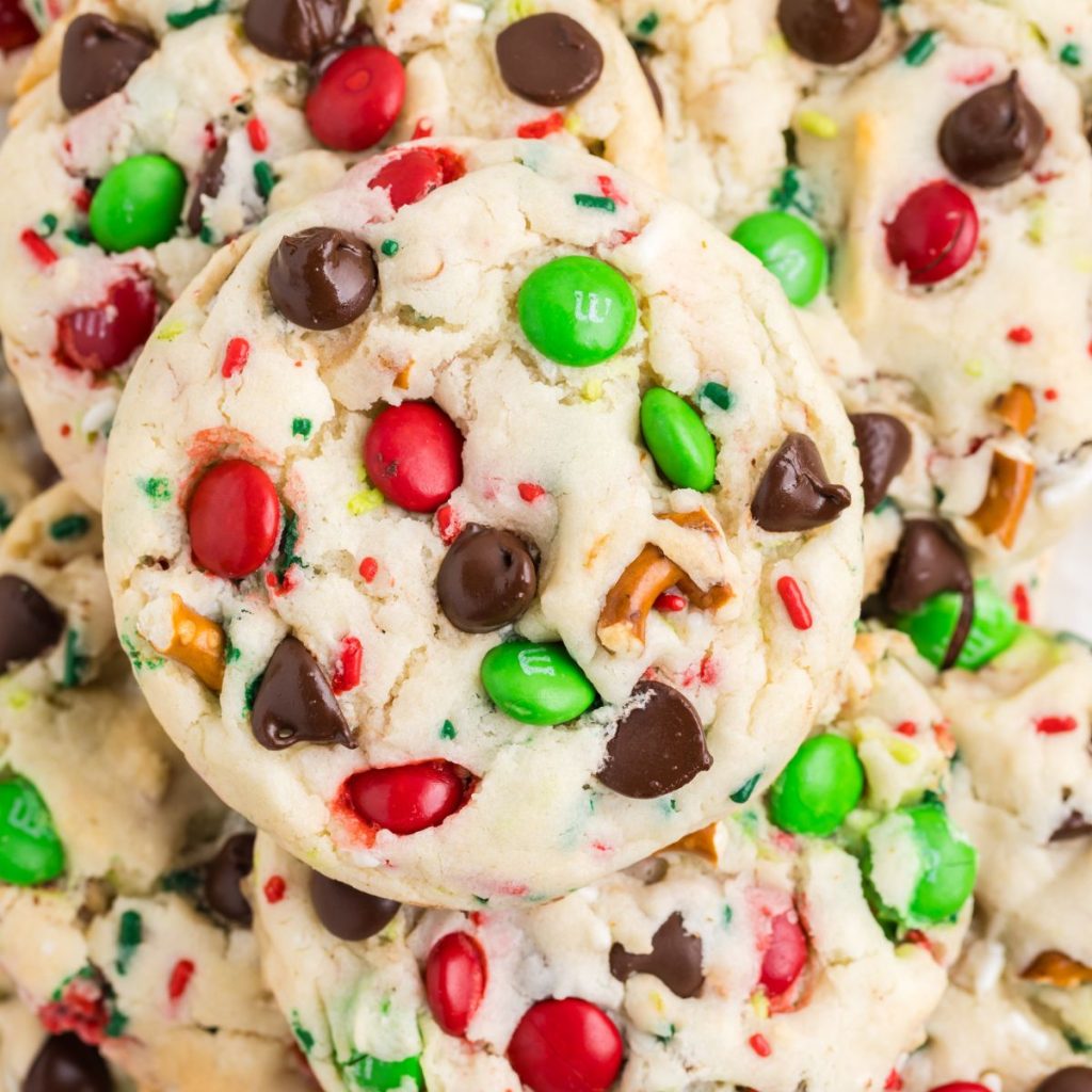 Close-up of cake mix Christmas cookies with red and green candy-coated chocolates, chocolate chips, and sprinkles.