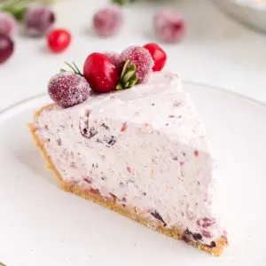 Slice of cranberry pie on a plate.