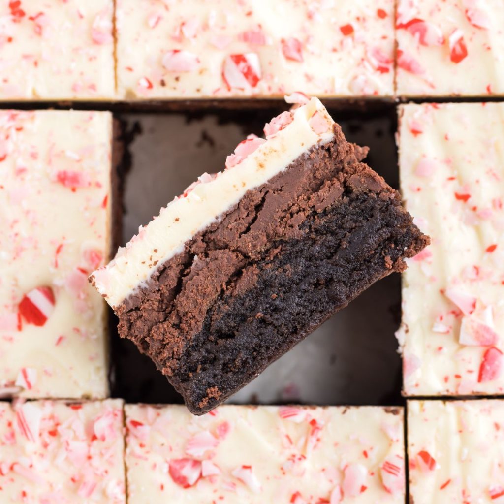 Peppermint bark brownie turned on its side exposing it's three layers.