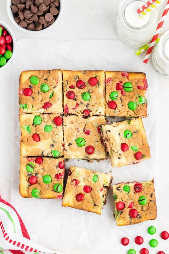 Christmas Cookie Cheesecake Bars laid out on counter.