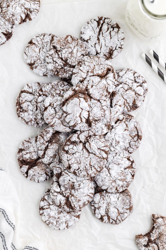 Stack of chocolate cool whip cookies on parchment paper.