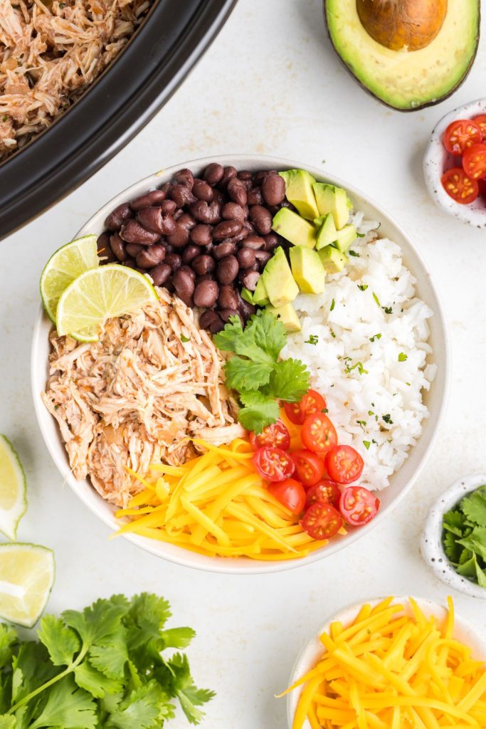 Slow Cooker Salsa Chicken used in a burrito bowl. 
