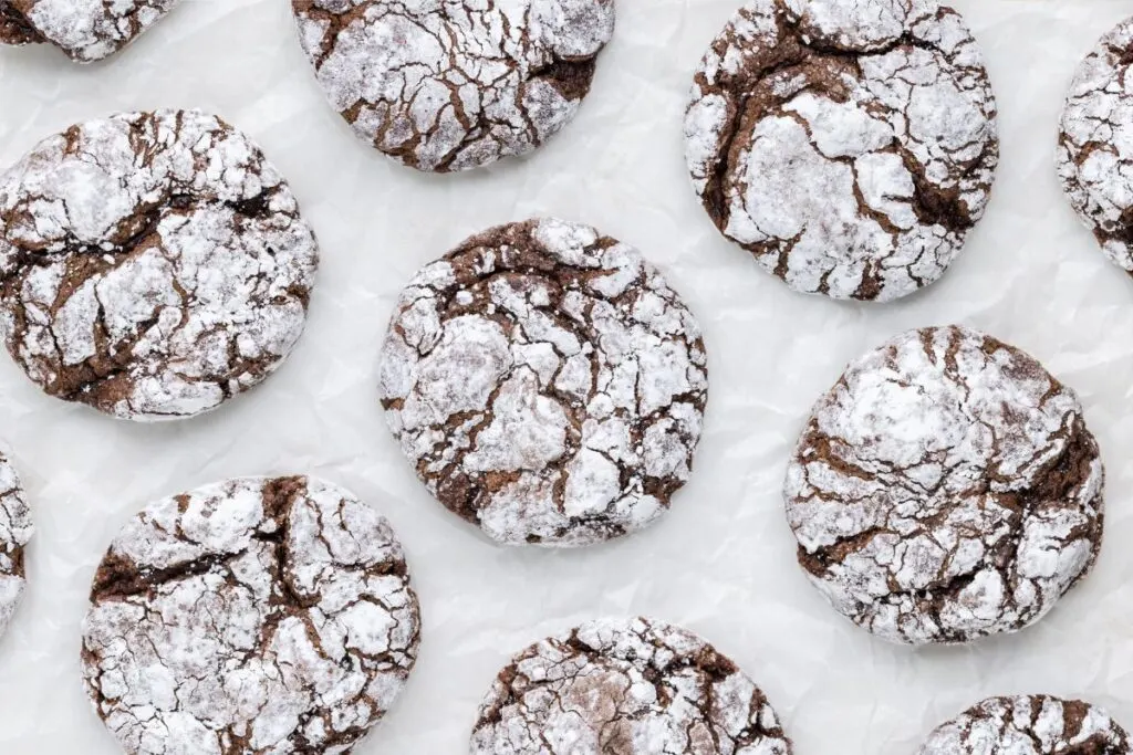 Chocolate Cool Whip crinkle cookies arranged on the counter.