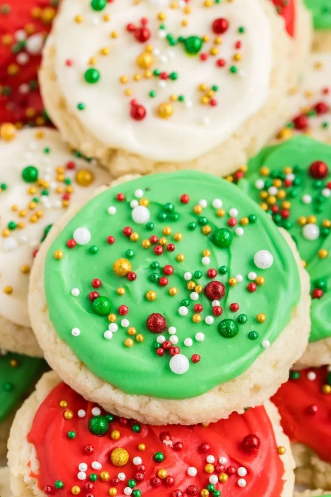 Close-up of a pile of frosted cream cheese sugar cookies. 