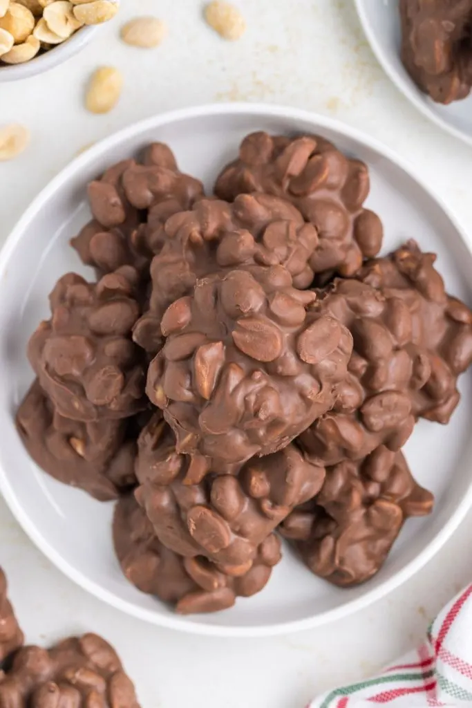 Pile of easy Crockpot Candy Clusters on a plate. 
