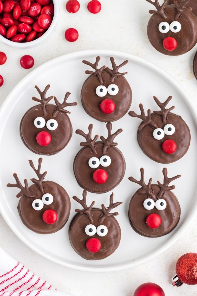 Chocolate Oreo reindeer displayed on a white platter. 