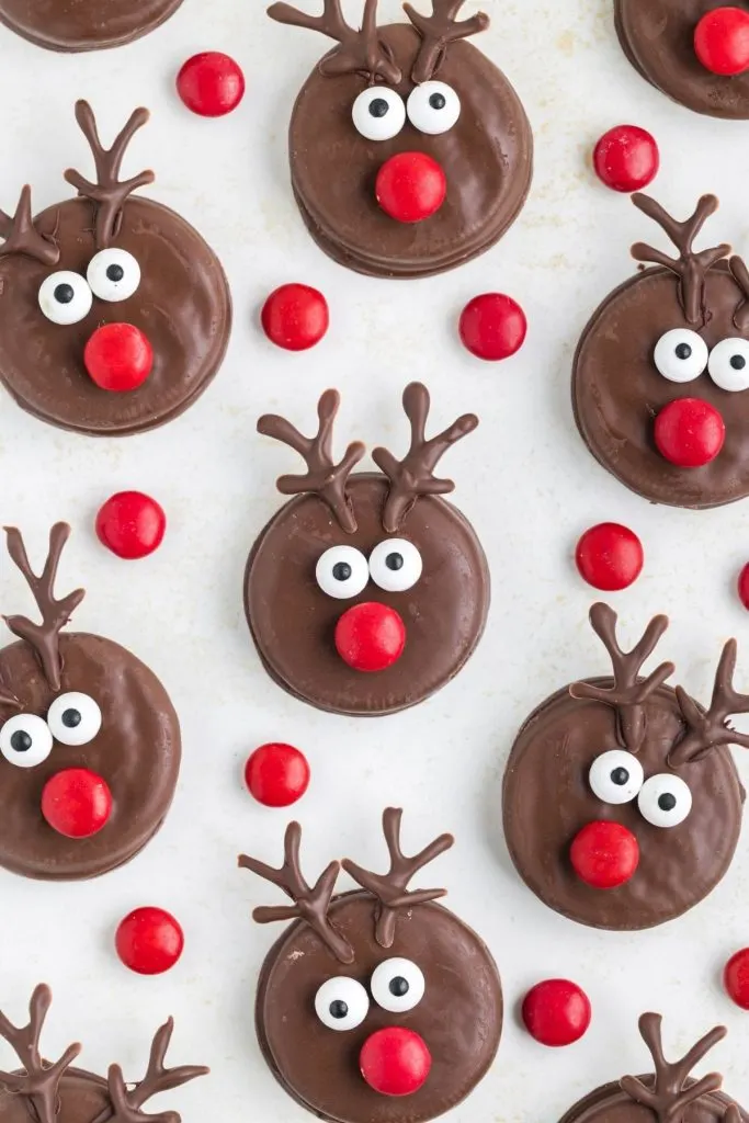 Oreo reindeer displayed on the counter surrounded by red M&Ms. 