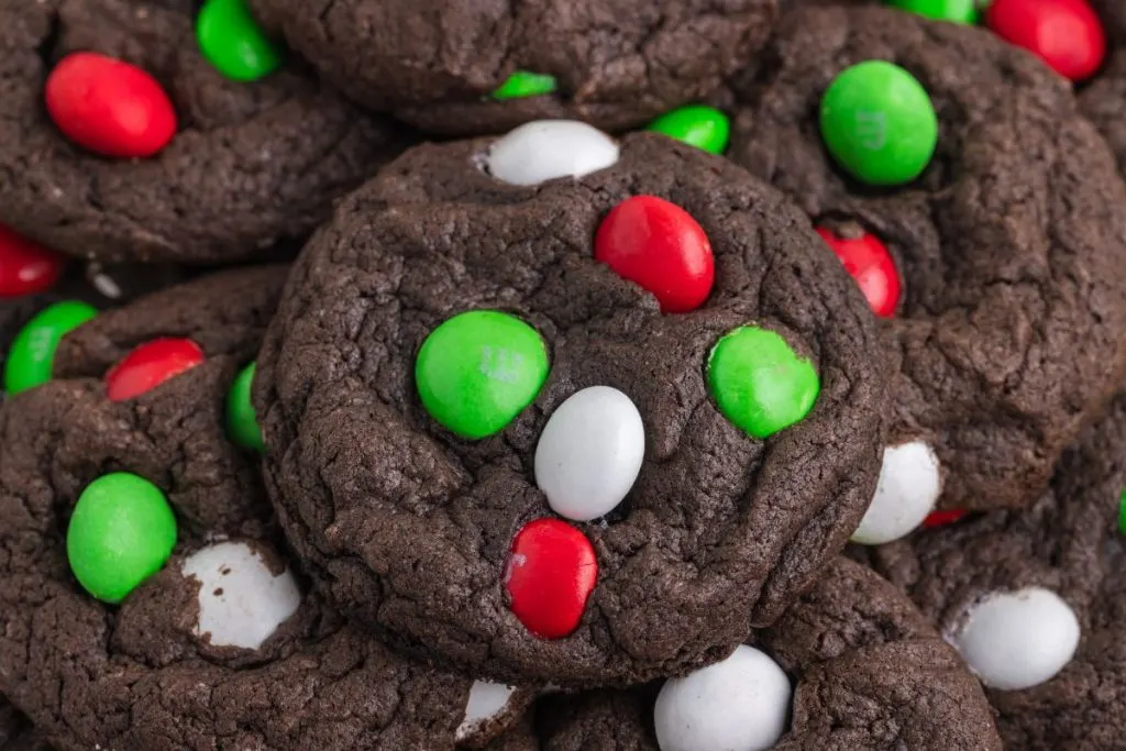 Close-up of a pile of M&M Chocolate Cake Mix Christmas Cookies. 