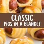 Mini sausages wrapped in golden crescent rolls on a white surface with parsley, labeled Crescent Roll Pigs in a Blanket.