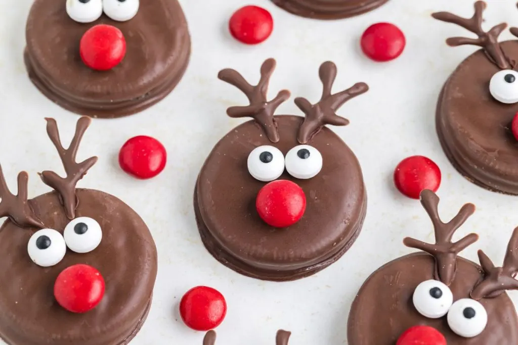 Oreo reindeer displayed on the counter surrounded by red M&Ms.
