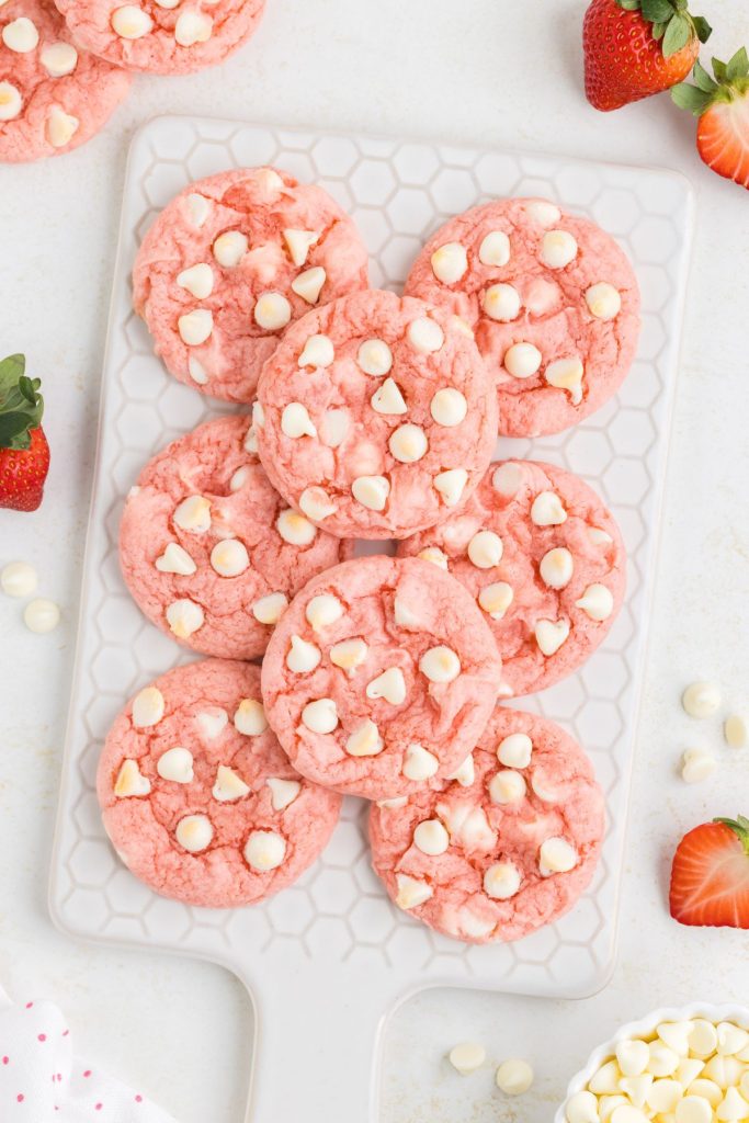 Strawberry cake mix cookies piled on a white tray.
