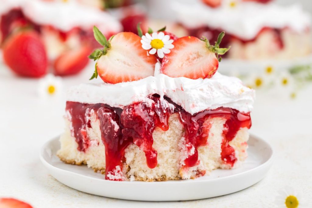 Slice of strawberry shortcake with bite missing. 