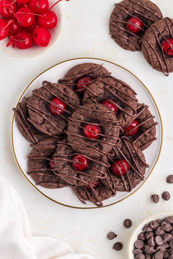 Chocolate cherry cookies piled on a plate. 