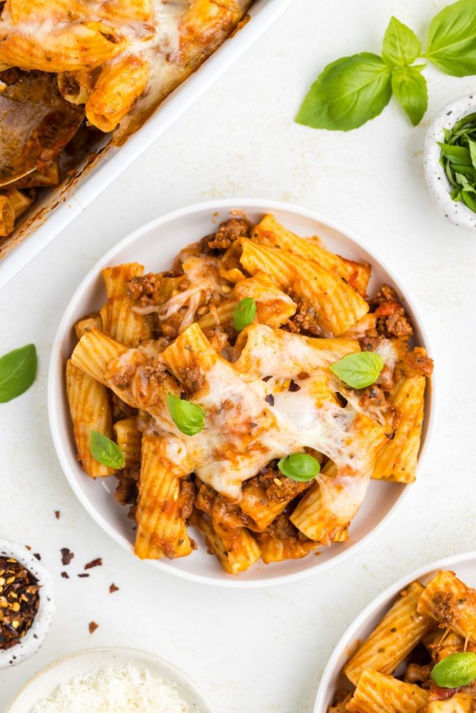 Baked rigatoni dish with layers of beef and cheese, served golden brown and bubbling with delicious flavors.