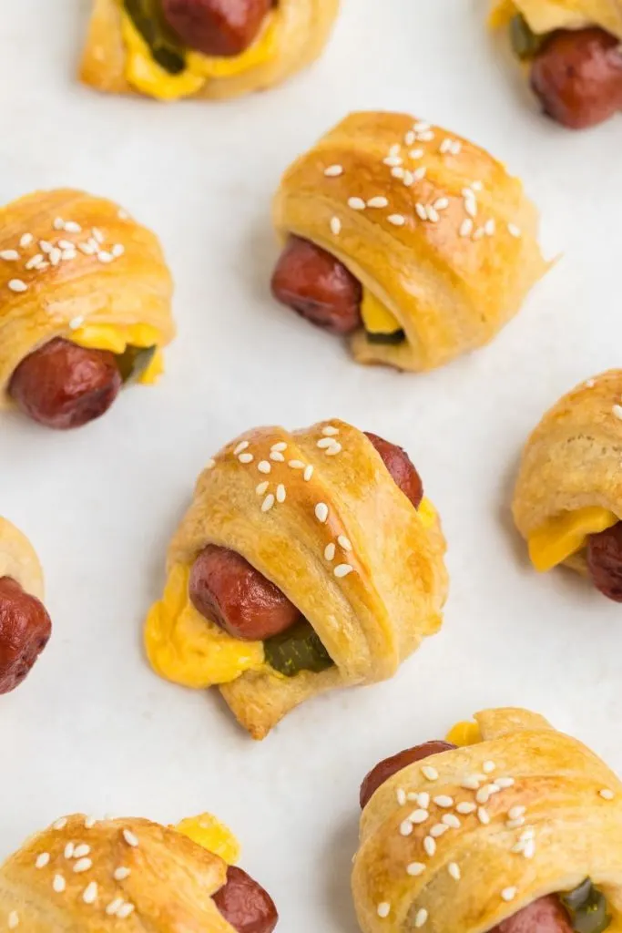 Cheeseburger pigs in a blanket on a baking tray. 