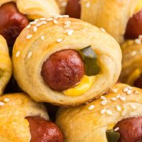 Pile of cheeseburger pigs in a blanket.