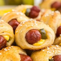 Pile of cheeseburger pigs in a blanket.