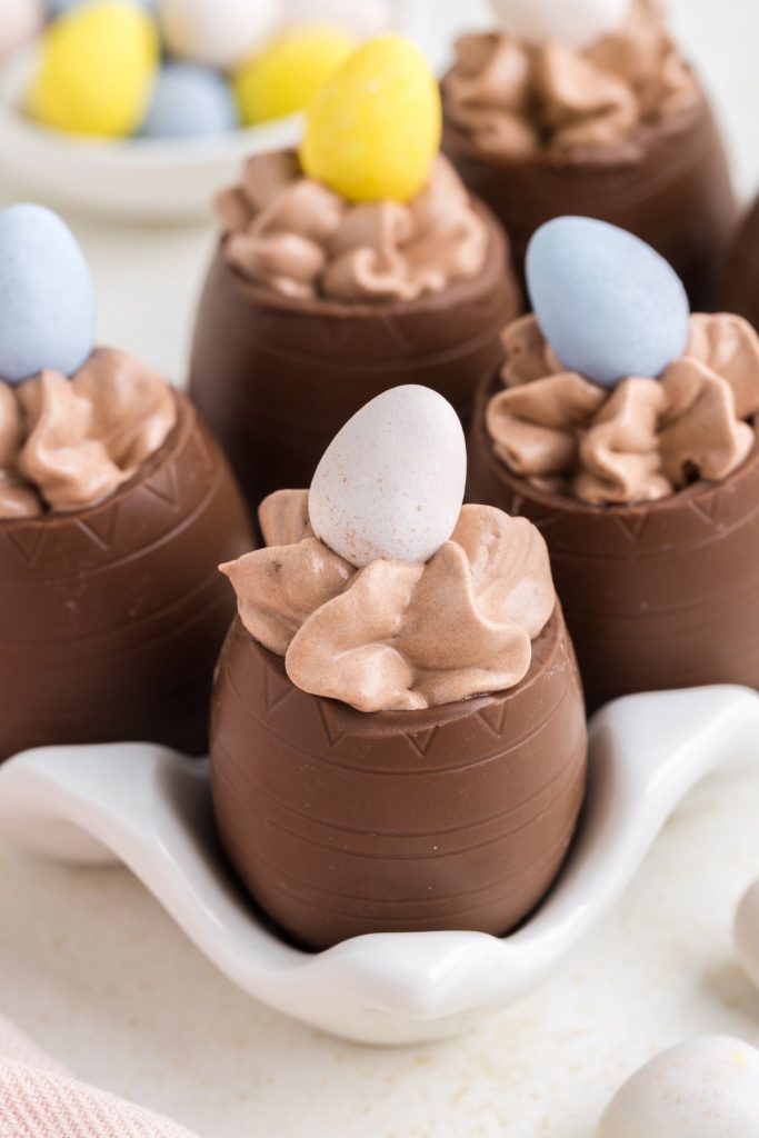 Chocolate mousse filled Easter eggs in a white egg carton. 