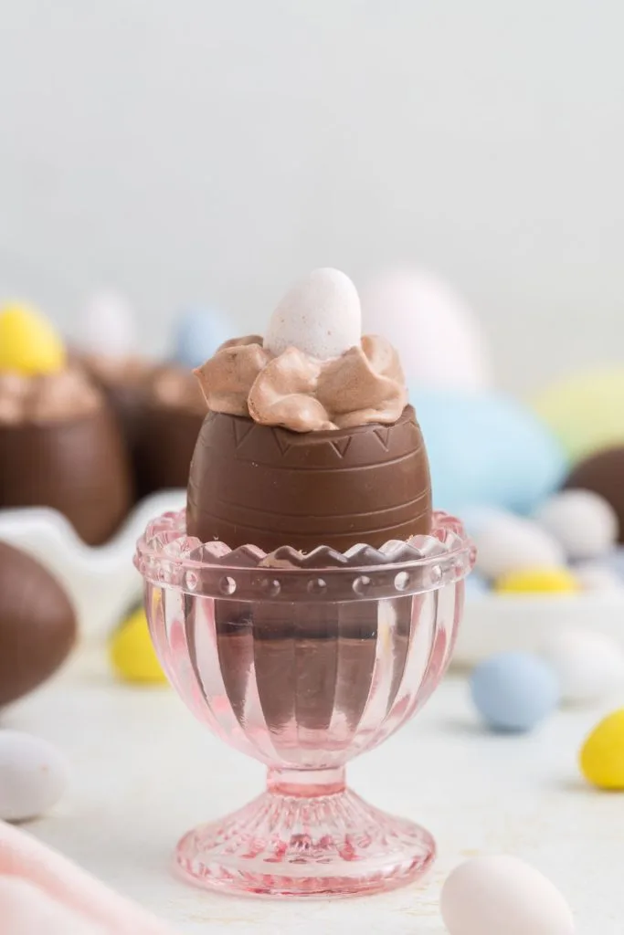 Chocolate mousse filled egg in a pink egg cup. 