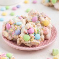 Plate full of white chocolate Easter candies with M&Ms and sprinkles.