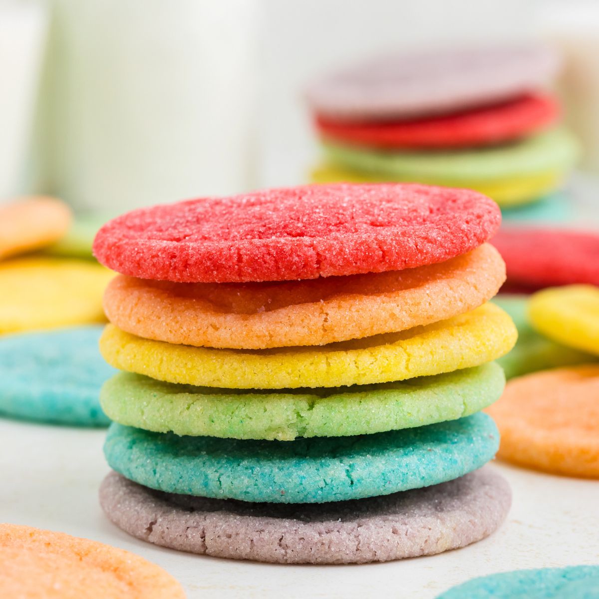 Six colored rainbow cookies on the counter.