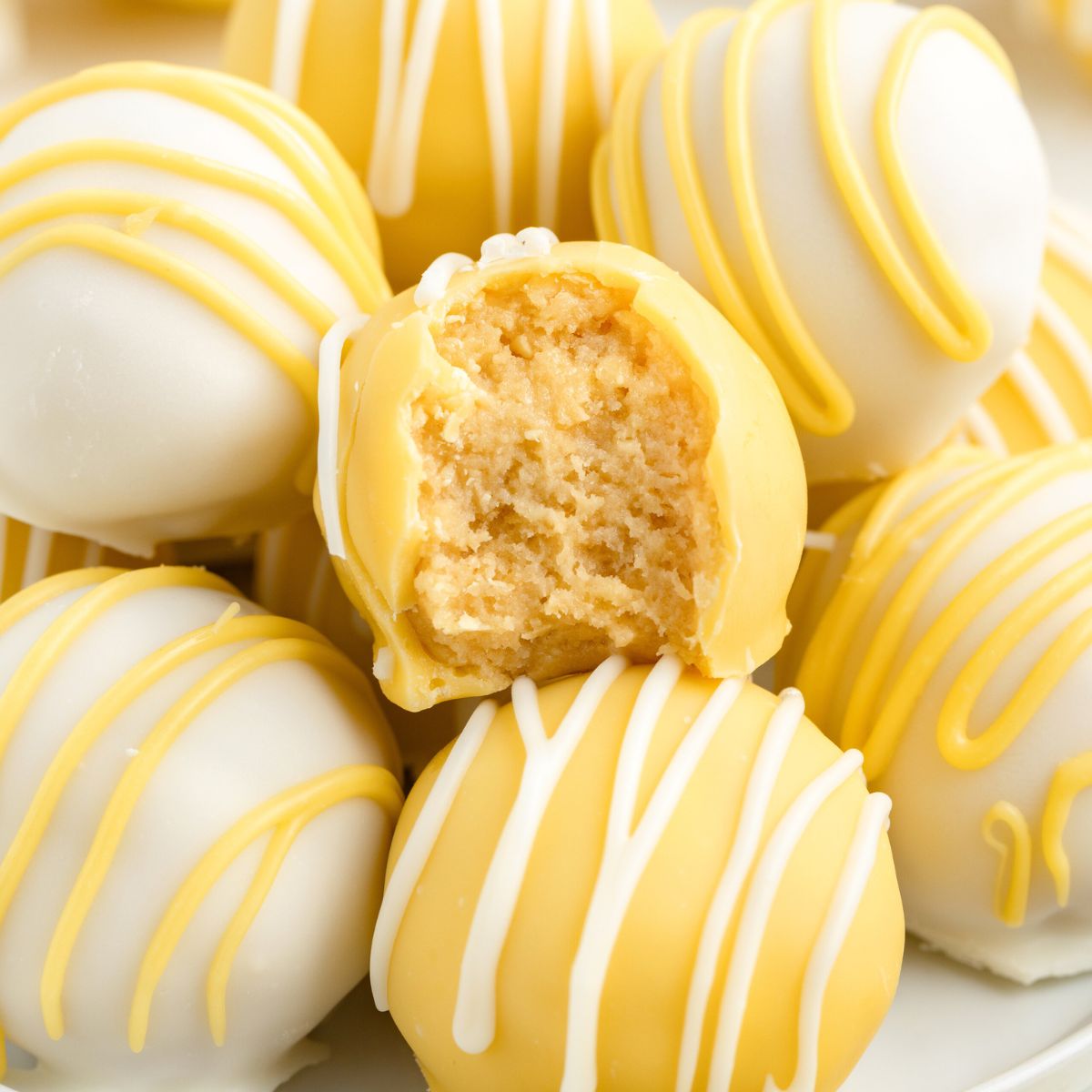 Pile of lemon Oreo truffle balls with creamy centers.