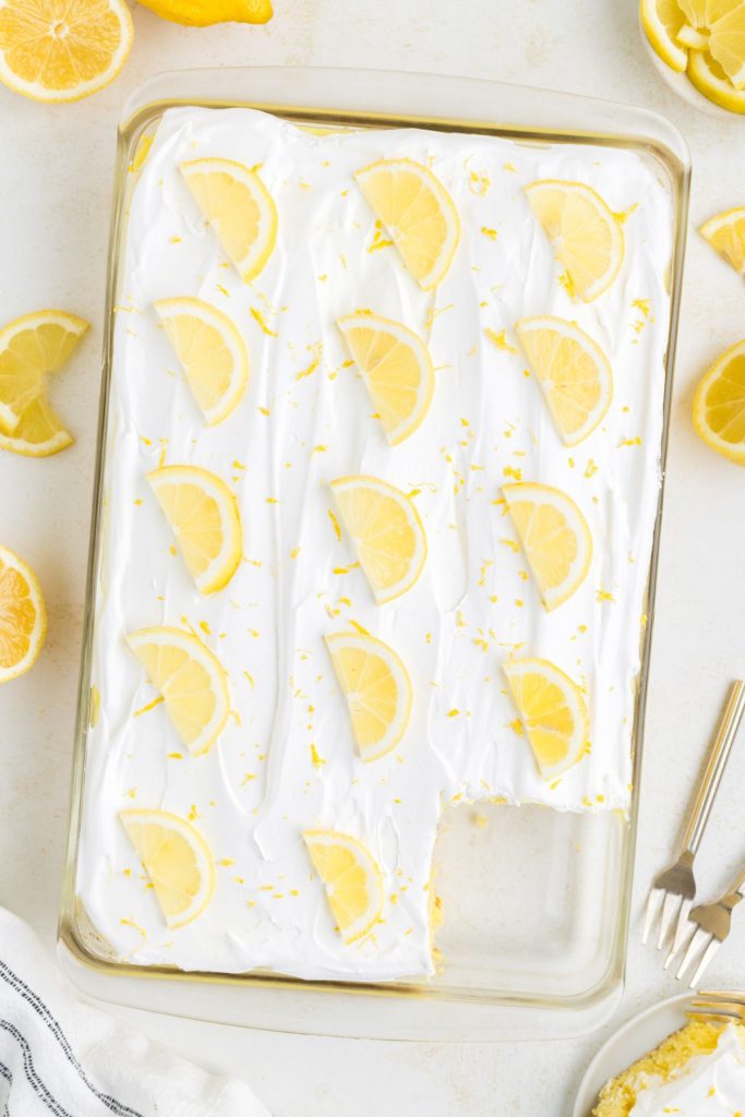 Lemon cake filled with lemon pudding and topped with Cool Whip and lemon slices. 
