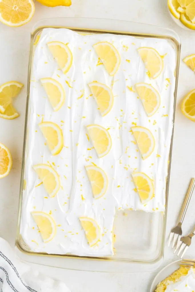 Lemon cake filled with lemon pudding and topped with Cool Whip and lemon slices. 