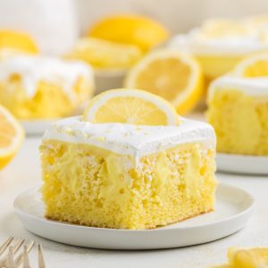Lemon poke cake filled with pudding and topped with Cool Whip.