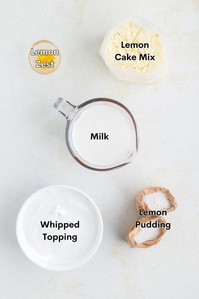 Ingredients such as cake mix, pudding mix, milk and whipped topping displayed on the counter. 