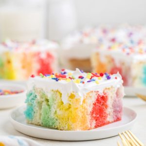 Bright poke cake with rainbow jello.
