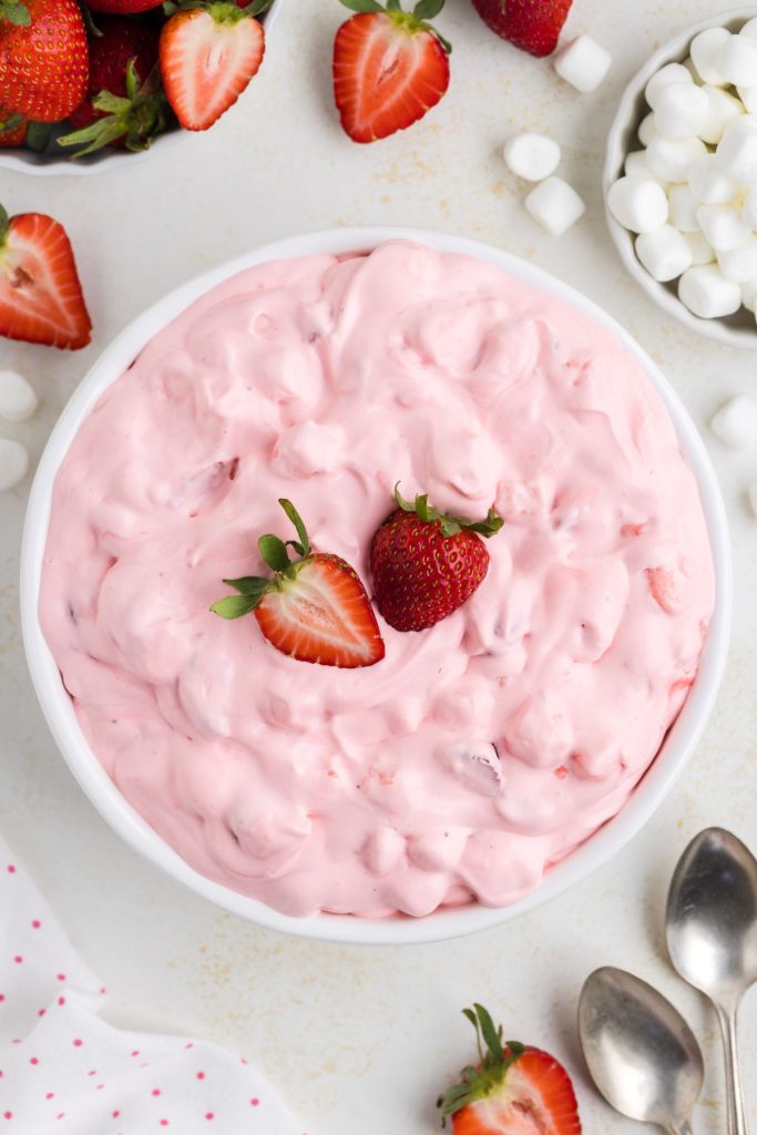 Bowl of no-bake strawberry marshmallow fluff on the counter.