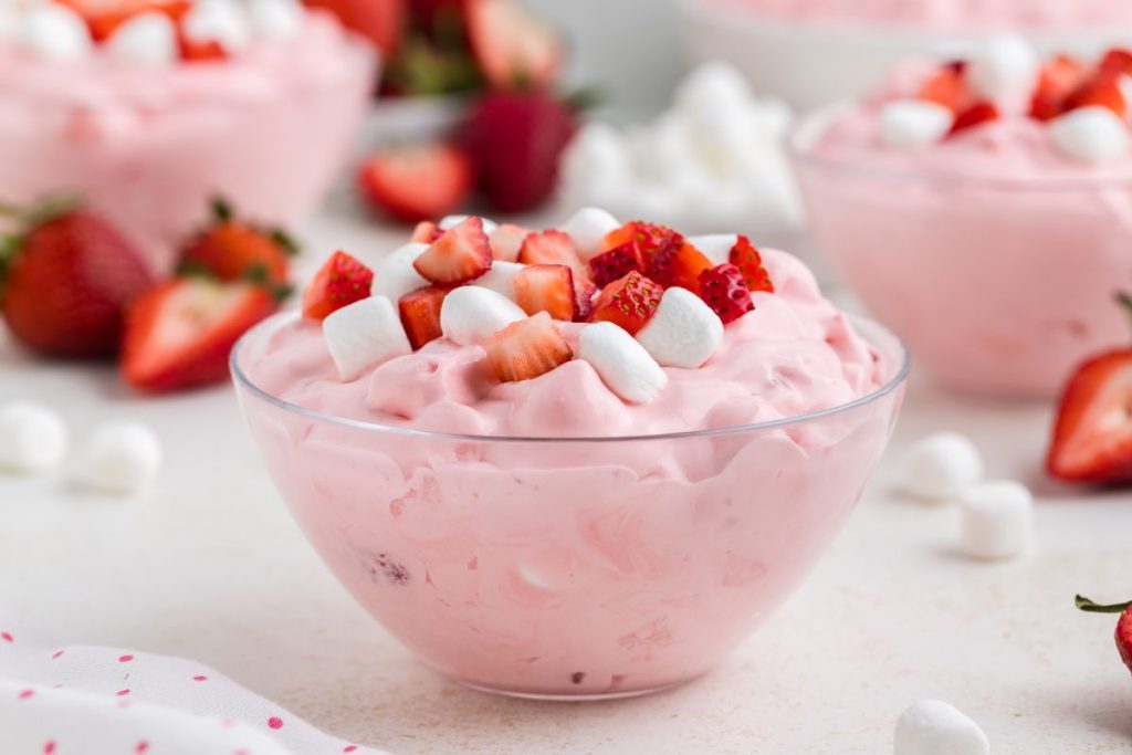 Three bowls of fluff salad with strawberry pie filling. 