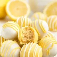 Plate of creamy lemon Oreo truffles coated in white and yellow chocolate.