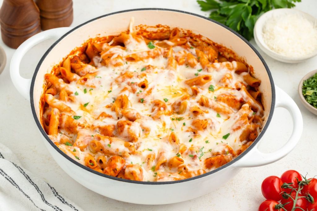 Chicken parmesan pasta in a large white skillet.