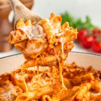 Spoonful of cheesy chicken parmesan pasta.