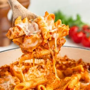 Spoonful of cheesy chicken parmesan pasta.