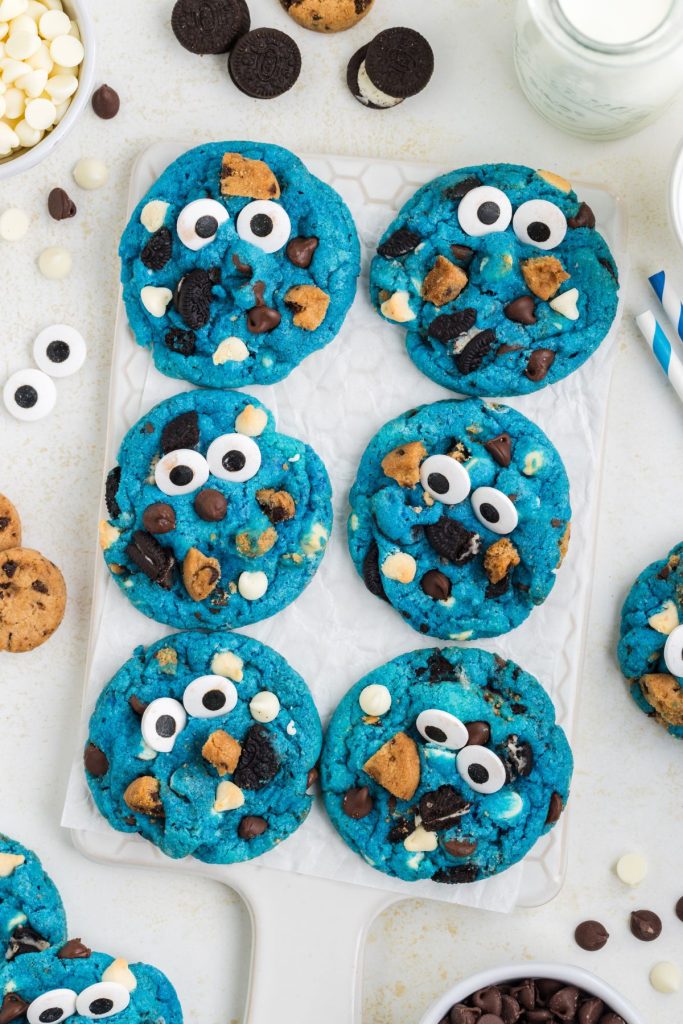 Six bright blue cookies with Oreos and chocolate chip cookies decorated like Cookie Monster.