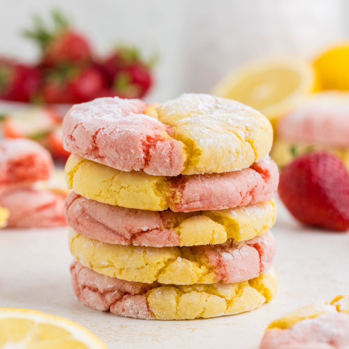 Pile of strawberry and lemon cake mix crinkle cookies.