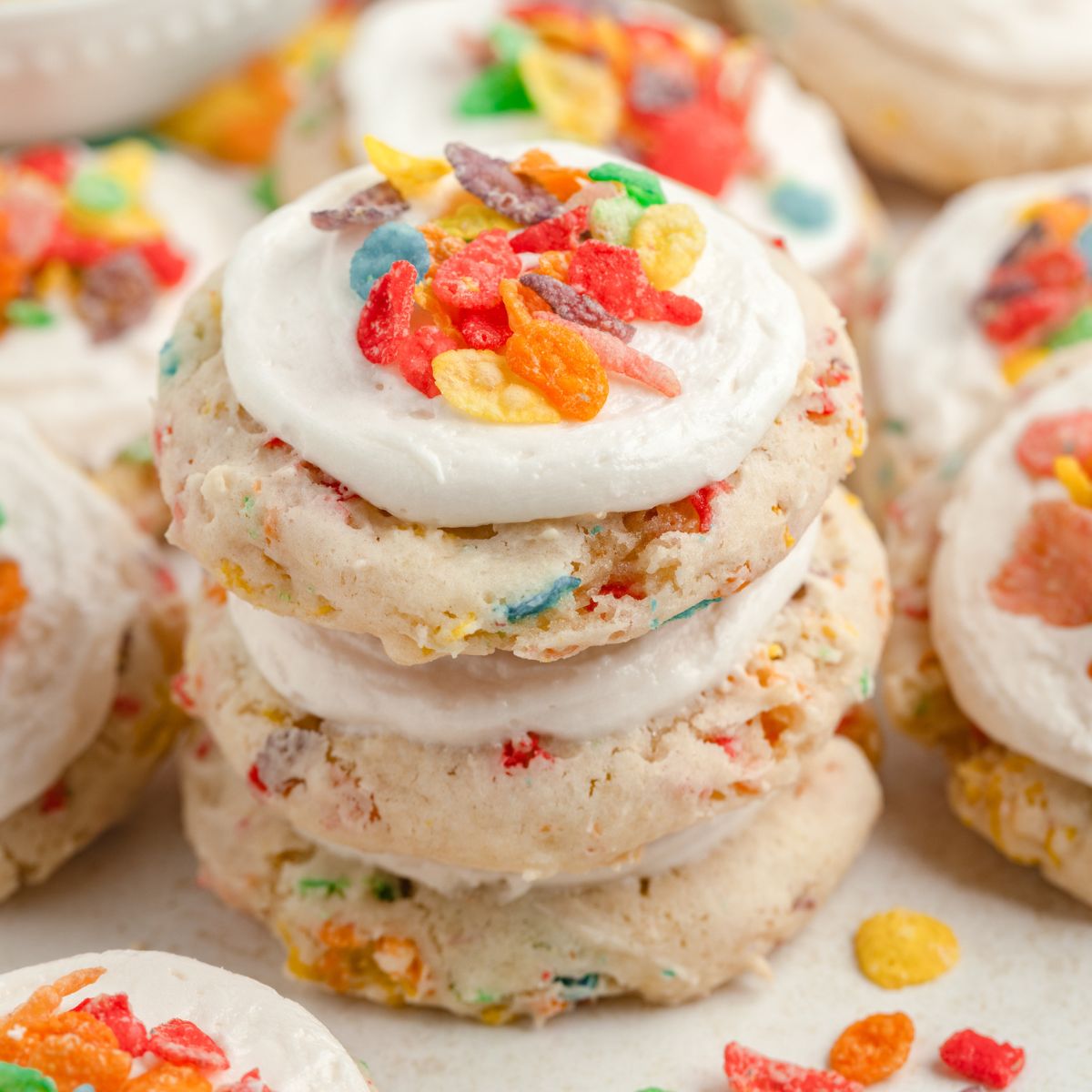 Stack of colorful frosted Fruity Pebble cake mix cookies.