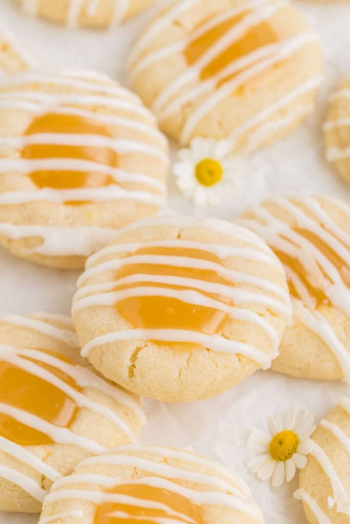 Pile of lemon thumbprint cookies filled with lemon curd.