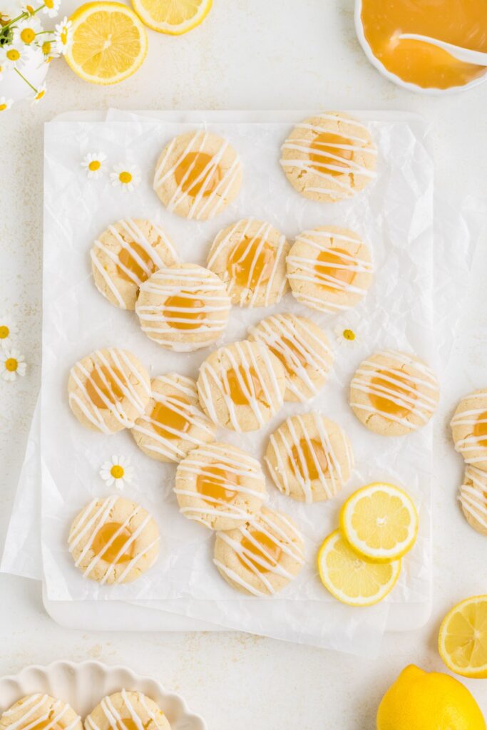 Lemon thumbprint cookies filled with curd and drizzled with glaze.