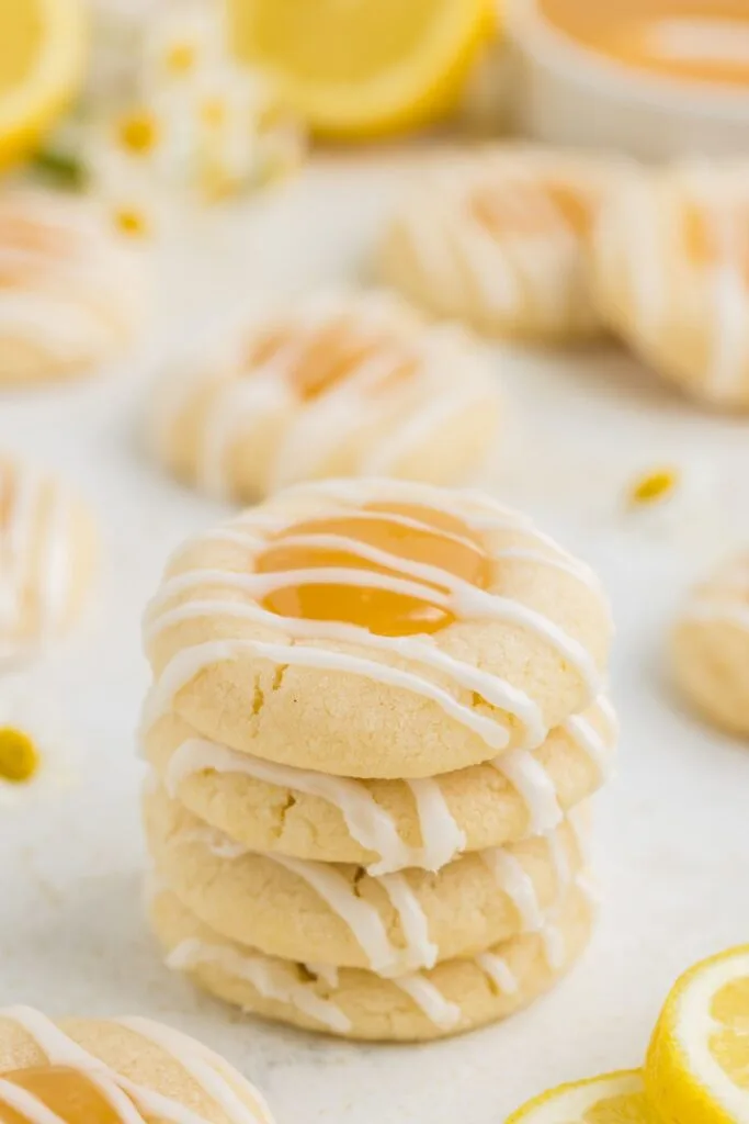 Stack of four lemon curd thumbprint cookies.