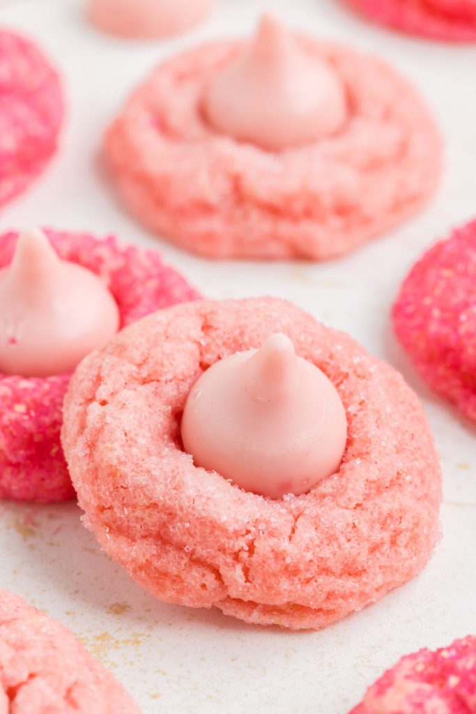 Light pink strawberry kiss cookie stacked on a hot pink cookie.