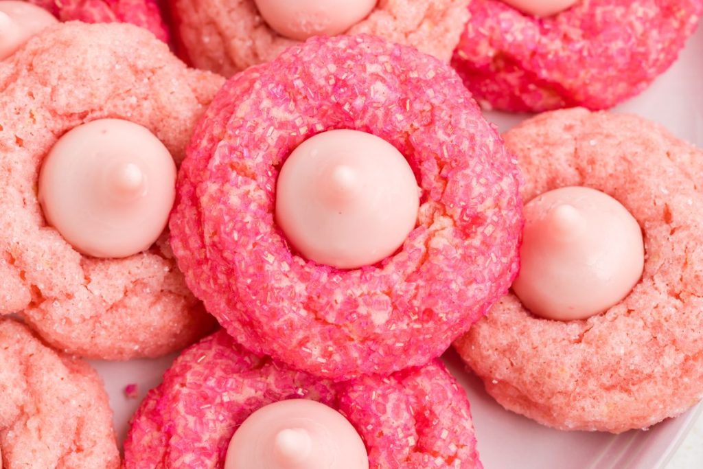 Pile of pink strawberry blossom cookies.