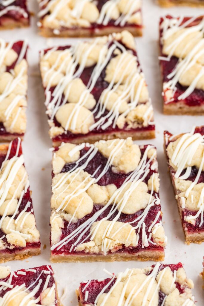 Cranberry and white chocolate crumb bars on the counter.