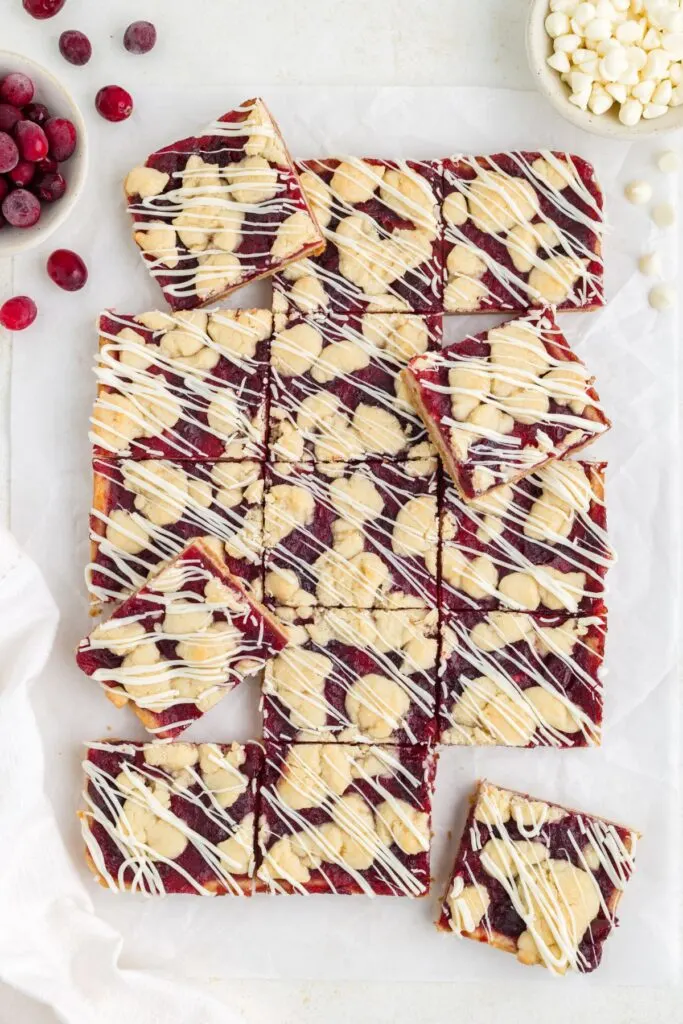 Cranberry white chocolate crumble bars cut into squares.