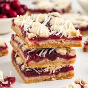 Stack of white chocolate cranberry crumb bars.